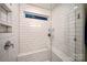 Elegant shower with white subway tile surround, built-in bench, and glass enclosure at 3899 Center Place Dr, Harrisburg, NC 28075