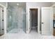 Bright bathroom featuring a glass enclosed shower with marble tile and decorative patterned floor tile at 4008 Nettie Ct # 3, Charlotte, NC 28211