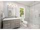 Clean bathroom showcasing a glass shower, gray vanity, and great natural light at 4008 Nettie Ct # 3, Charlotte, NC 28211