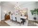 Beautiful dining room with modern chandelier, stylish sideboard, and view into kitchen at 4008 Nettie Ct # 3, Charlotte, NC 28211