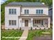 A grand two-story brick home showcases its beautiful front yard and covered front porch at 4008 Nettie Ct # 3, Charlotte, NC 28211