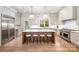 Bright kitchen boasts a large island with seating, stainless steel appliances, and hardwood floors at 4008 Nettie Ct # 3, Charlotte, NC 28211