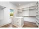 Bright, spacious walk-in closet with custom shelving, a center island, and a window for natural light at 4008 Nettie Ct # 3, Charlotte, NC 28211
