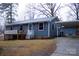 Charming one-story home with a covered front porch, mature trees, and a convenient carport at 522 Perry St, Troy, NC 27371