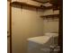 Functional laundry room with shelving and a washing machine at 522 Perry St, Troy, NC 27371