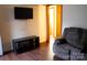 Cozy living room with modern entertainment setup and comfortable recliner at 522 Perry St, Troy, NC 27371