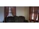 Inviting living room with comfortable seating and natural light streaming through two windows at 522 Perry St, Troy, NC 27371