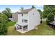 A two-story home featuring a back deck with stairs leading to the backyard with lawn at 531 Harlech Ct, Fort Mill, SC 29715