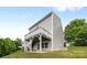 A two-story home showcasing a spacious deck and backyard area surrounded by lush greenery at 531 Harlech Ct, Fort Mill, SC 29715