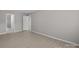Neutral bedroom with wood-look flooring and two entry doors at 531 Harlech Ct, Fort Mill, SC 29715