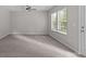 Spacious bedroom with plush carpet, a ceiling fan, and a large window at 531 Harlech Ct, Fort Mill, SC 29715