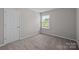 Neutral carpeted bedroom featuring natural light from a window at 531 Harlech Ct, Fort Mill, SC 29715