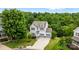 An aerial view of a charming two-story home with a well-manicured lawn and lush green trees at 531 Harlech Ct, Fort Mill, SC 29715