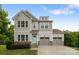 Charming two-story home featuring a light blue front door and a two-car garage at 531 Harlech Ct, Fort Mill, SC 29715