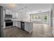 Stylish kitchen seamlessly connected to the living area, featuring stainless steel appliances and granite countertops at 531 Harlech Ct, Fort Mill, SC 29715