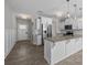 Open-concept kitchen featuring white cabinets, granite countertops, stainless steel appliances, and modern lighting fixtures at 531 Harlech Ct, Fort Mill, SC 29715