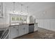 Well-lit kitchen with stainless steel appliances, granite countertops, and an open layout to adjacent living spaces at 531 Harlech Ct, Fort Mill, SC 29715