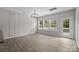 Bright living area with wood floors, modern lighting, and a seamless transition to the outdoor deck at 531 Harlech Ct, Fort Mill, SC 29715