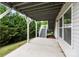 Covered patio with concrete floor, white support beams and stairs to the yard at 531 Harlech Ct, Fort Mill, SC 29715