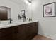 Bathroom with dual sink vanity, modern fixtures, and decorative accents at 5520 Chedworth Dr, Charlotte, NC 28210