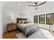 Serene bedroom with natural light, ceiling fan, hardwood floors, and neutral decor at 5520 Chedworth Dr, Charlotte, NC 28210