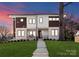 Stunning two-story home with a manicured lawn, modern design, and inviting entrance at 5520 Chedworth Dr, Charlotte, NC 28210