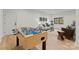 This spacious game room features a foosball table and cozy seating area with bright, natural light at 5520 Chedworth Dr, Charlotte, NC 28210