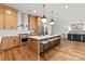 Bright kitchen with stainless steel appliances, a large island, and hardwood floors at 5520 Chedworth Dr, Charlotte, NC 28210