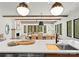 Modern kitchen features a large island, stylish lighting, and flows seamlessly into the dining and living areas at 5520 Chedworth Dr, Charlotte, NC 28210
