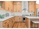 Bright kitchen featuring wood cabinets, white countertops, and stainless steel appliances at 5520 Chedworth Dr, Charlotte, NC 28210