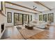 Spacious living room features wood beam ceilings, fireplace, rustic wood floors, and access to the outdoors at 5520 Chedworth Dr, Charlotte, NC 28210