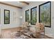 Bright living room with hardwood floors, beamed ceiling, modern furniture, and a view of the surrounding trees at 5520 Chedworth Dr, Charlotte, NC 28210