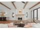 Bright living room offers wood beam ceilings, fireplace, stylish seating, and rustic wood floors at 5520 Chedworth Dr, Charlotte, NC 28210