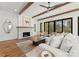 Cozy living room features exposed wood beams, a brick fireplace, and comfortable seating, perfect for relaxation at 5520 Chedworth Dr, Charlotte, NC 28210