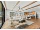 Open-concept living room with wood beam ceilings, rustic floors, flows into the kitchen, and access to the outdoors at 5520 Chedworth Dr, Charlotte, NC 28210