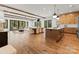 Open-concept living space with exposed beams, hardwood floors, and large windows, perfect for entertaining and relaxation at 5520 Chedworth Dr, Charlotte, NC 28210