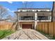 Back of home showing two stories, garage, and outdoor balconies with fans and modern railings at 5520 Chedworth Dr, Charlotte, NC 28210