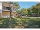 Exterior of home featuring a spacious backyard, wooden staircase, and a fenced yard at 5610 Farmbrook Dr, Charlotte, NC 28210
