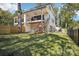 View of the house with a well-maintained lawn and dark metal fencing around the perimeter of the property at 5610 Farmbrook Dr, Charlotte, NC 28210