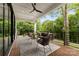 Spacious covered balcony features a seating area with plush outdoor furniture at 5610 Farmbrook Dr, Charlotte, NC 28210