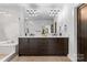 This bathroom features a dual sink vanity, glass shower, and modern lighting at 5610 Farmbrook Dr, Charlotte, NC 28210