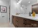 Modern bathroom with double vanity, sleek fixtures, and a large mirror at 5610 Farmbrook Dr, Charlotte, NC 28210