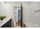 This bathroom features a modern vanity, bathtub, and wood door at 5610 Farmbrook Dr, Charlotte, NC 28210