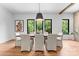 Bright dining room with a large table, comfortable seating, and modern lighting fixtures at 5610 Farmbrook Dr, Charlotte, NC 28210