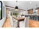 Bright dining room features a wooden table, cushioned chairs, wood floors, and exposed wood beam ceiling at 5610 Farmbrook Dr, Charlotte, NC 28210