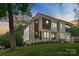 Beautiful modern home showcasing a well-maintained lawn, contemporary architecture, and elegant landscaping at 5610 Farmbrook Dr, Charlotte, NC 28210
