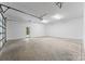 Spacious garage with ample room and a door leading to the outside at 5610 Farmbrook Dr, Charlotte, NC 28210