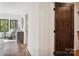 The hallway has dark wood floors and a sitting area with outdoor views at 5610 Farmbrook Dr, Charlotte, NC 28210