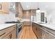 This kitchen features stainless steel appliances, ample counter space, custom cabinets and sleek, modern design at 5610 Farmbrook Dr, Charlotte, NC 28210