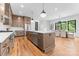 Open kitchen features an island with seating, stainless appliances, and a view to the dining area at 5610 Farmbrook Dr, Charlotte, NC 28210